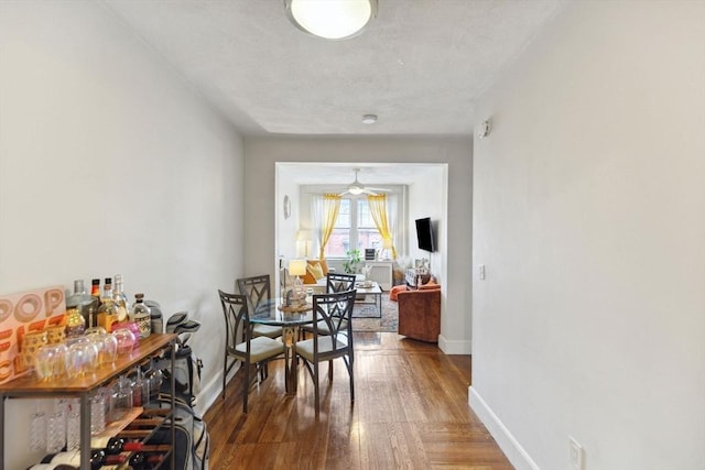 dining space featuring wood finished floors and baseboards