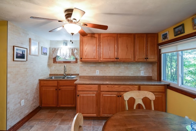 kitchen featuring sink, decorative backsplash, and ceiling fan