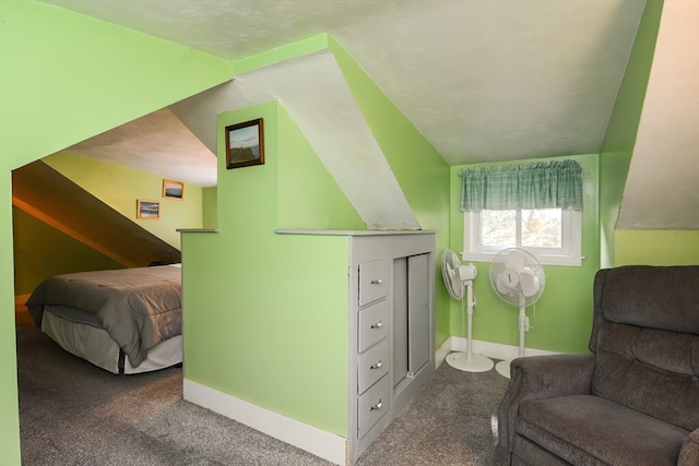 bedroom with vaulted ceiling and dark carpet