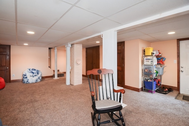 sitting room with a paneled ceiling and carpet