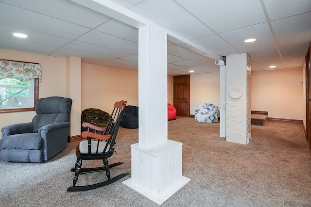 basement featuring a drop ceiling and carpet flooring