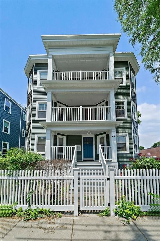 32 Gibson Unit 2, Boston, MA 02122 - view of front of property featuring a balcony, a porch, and a fenced front yard