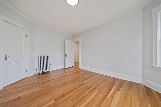 32 Gibson Unit 2, Boston, MA 02122 - empty room with radiator heating unit, ornamental molding, and light wood finished floors