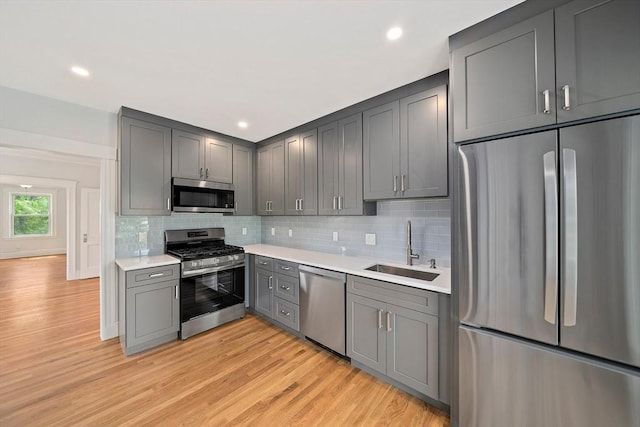 32 Gibson Unit 2, Boston, MA 02122 - kitchen featuring appliances with stainless steel finishes, gray cabinets, light countertops, decorative backsplash, and recessed lighting