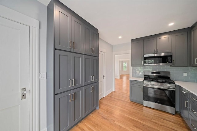 32 Gibson Unit 2, Boston, MA 02122 - kitchen with appliances with stainless steel finishes, tasteful backsplash, light countertops, light wood-style floors, and gray cabinetry