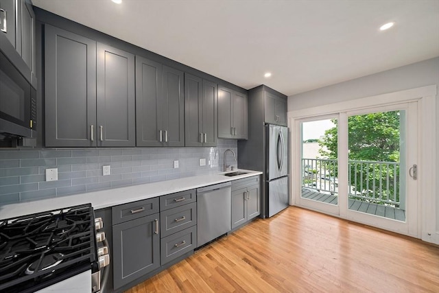32 Gibson Unit 2, Boston, MA 02122 - kitchen with stainless steel appliances, light countertops, decorative backsplash, light wood-type flooring, and recessed lighting