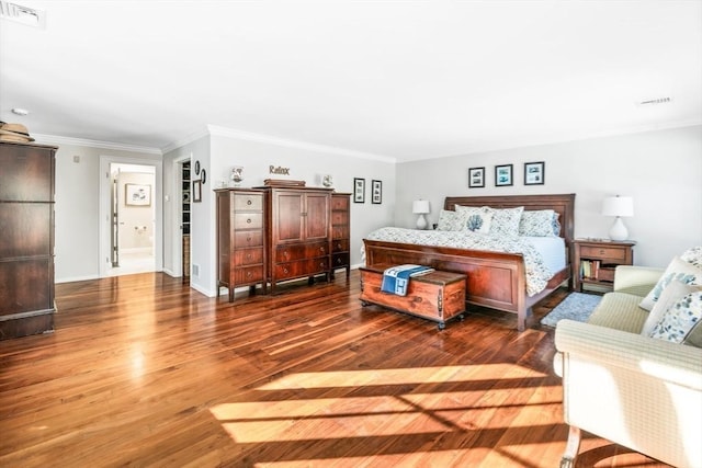 bedroom featuring hardwood / wood-style flooring and ornamental molding