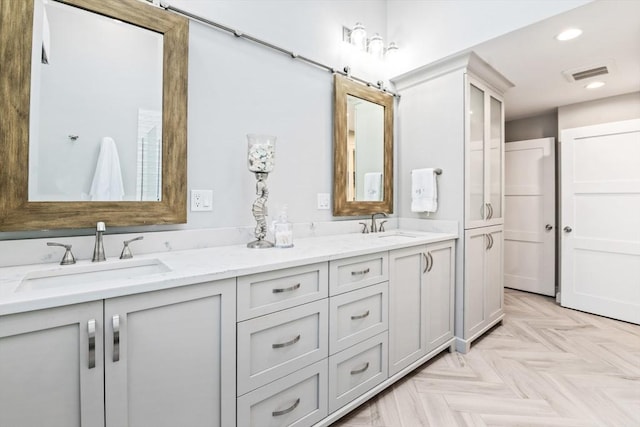 bathroom with vanity and parquet floors