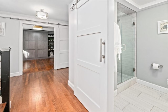 bathroom featuring hardwood / wood-style floors and an enclosed shower