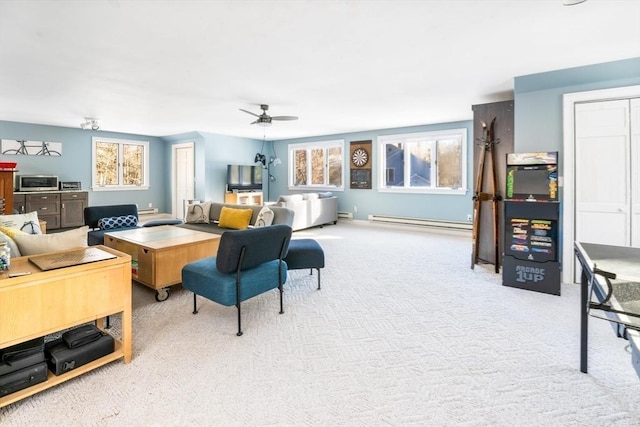 carpeted living room with ceiling fan and a baseboard radiator