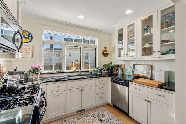 kitchen with white cabinetry, sink, crown molding, and appliances with stainless steel finishes