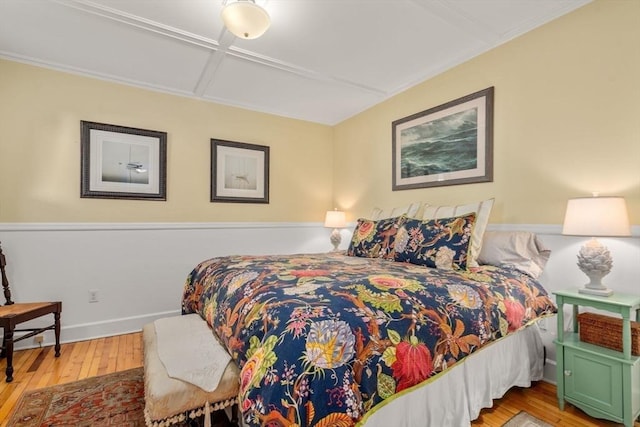 bedroom featuring coffered ceiling and light wood-type flooring