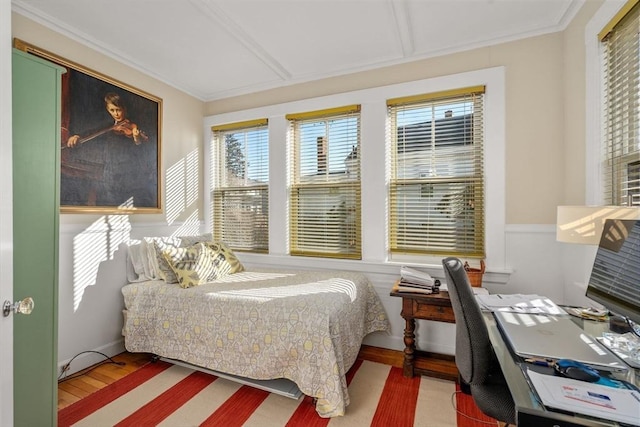 bedroom with hardwood / wood-style flooring and ornamental molding