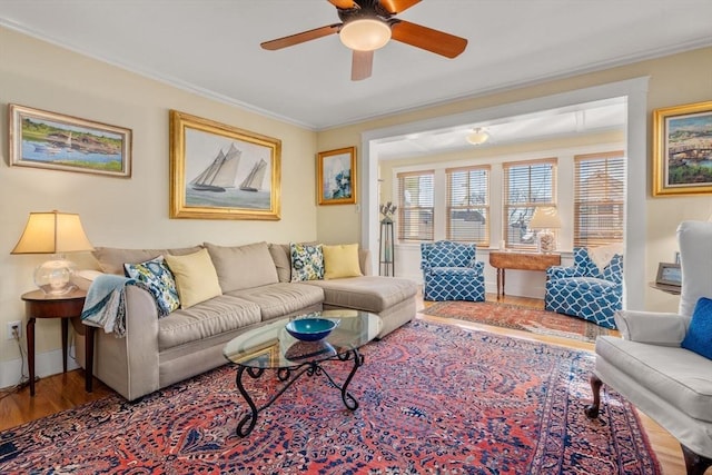 living room with ceiling fan, ornamental molding, and hardwood / wood-style floors