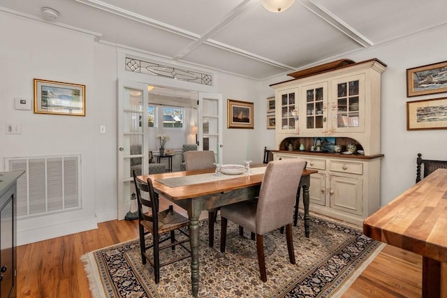 dining room with coffered ceiling and wood-type flooring