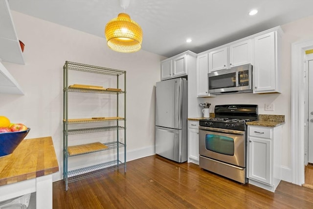 kitchen with appliances with stainless steel finishes, dark wood-style floors, white cabinetry, baseboards, and recessed lighting