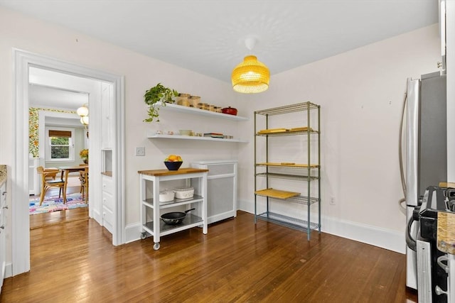 bedroom with wood finished floors and baseboards