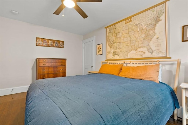 bedroom with wood finished floors, baseboards, and ceiling fan