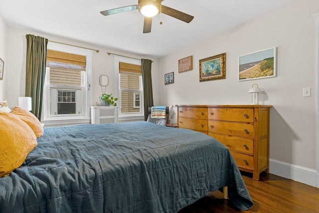 bedroom with wood finished floors, baseboards, and a ceiling fan