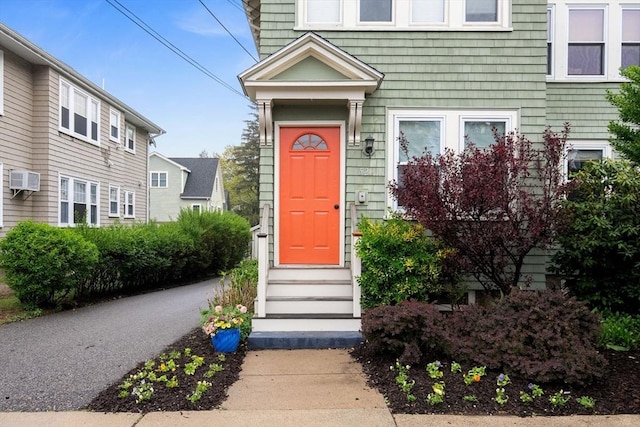 doorway to property with an AC wall unit