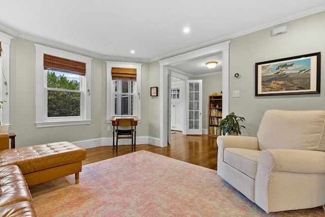 living room featuring wood finished floors, recessed lighting, crown molding, and baseboards