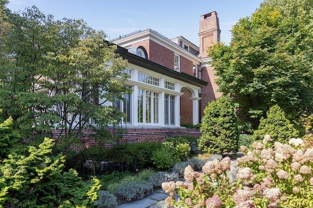 87 Hammond St, Newton, MA 02467 - view of home's exterior featuring brick siding and a chimney