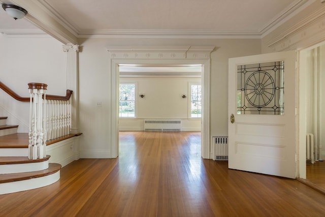 entryway featuring crown molding, radiator heating unit, and hardwood / wood-style flooring