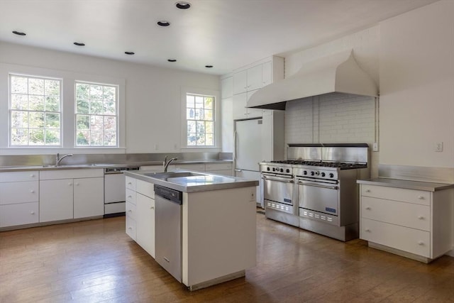 87 Hammond St, Newton, MA 02467 - kitchen with stainless steel countertops, double oven range, a sink, dishwasher, and custom range hood