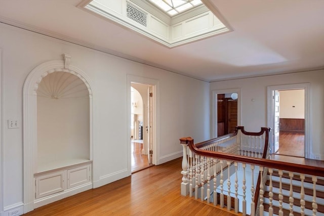 87 Hammond St, Newton, MA 02467 - hallway featuring an upstairs landing, light wood-style floors, and arched walkways
