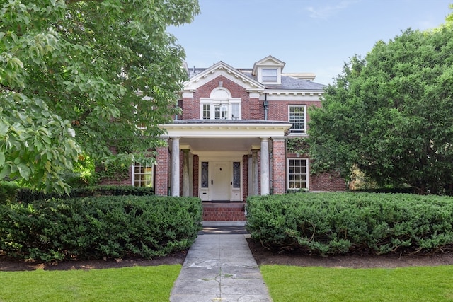 view of front of house featuring a front yard and covered porch