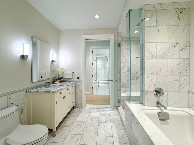 full bathroom with vanity, toilet, and independent shower and bath