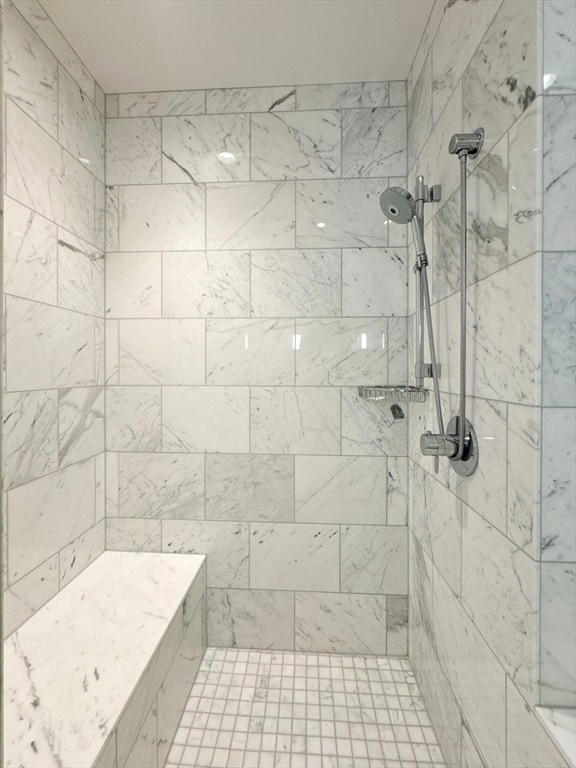 bathroom with tiled shower