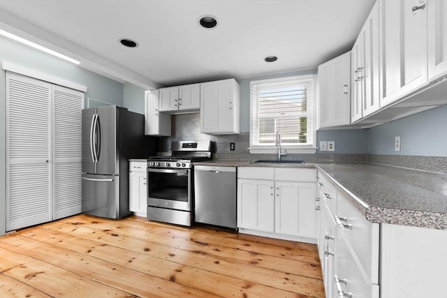 80 Lennox Rd Unit 1, Nahant, MA 01908 - kitchen featuring stainless steel appliances, a sink, white cabinets, light wood-type flooring, and recessed lighting