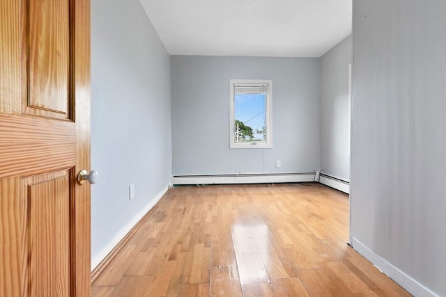 80 Lennox Rd Unit 1, Nahant, MA 01908 - spare room featuring a baseboard heating unit, light wood-type flooring, and baseboards