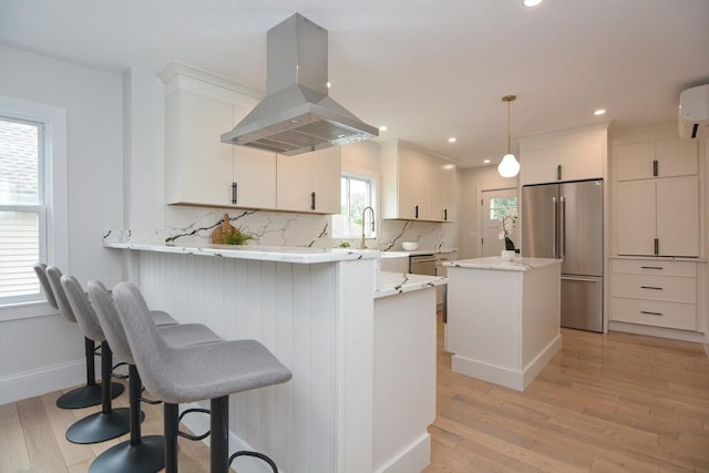 57 Garrison Ave Unit 57, Somerville, MA 02144 - kitchen featuring high end fridge, island range hood, light wood-style flooring, backsplash, and recessed lighting