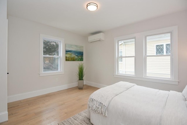 57 Garrison Ave Unit 57, Somerville, MA 02144 - bedroom featuring a wall mounted air conditioner and light wood-type flooring