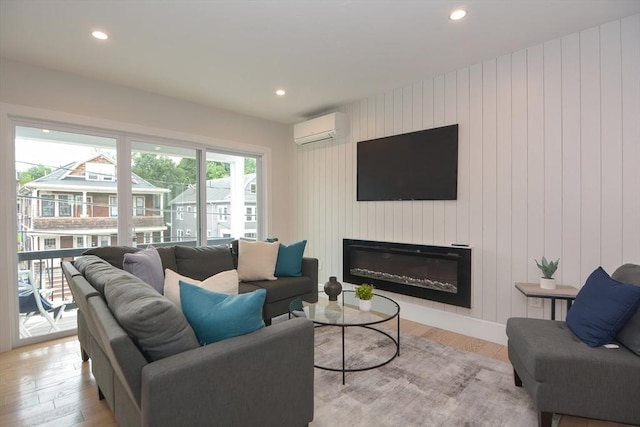 57 Garrison Ave Unit 57, Somerville, MA 02144 - living area featuring a wall unit AC, light wood-type flooring, recessed lighting, and a glass covered fireplace