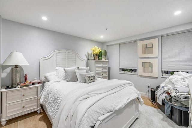 bedroom featuring wood finished floors and recessed lighting