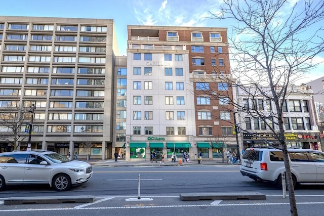 view of building exterior featuring uncovered parking