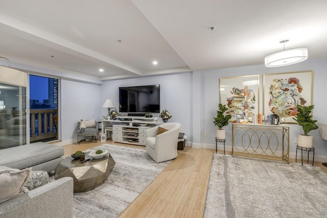 living area with recessed lighting, wood finished floors, and baseboards
