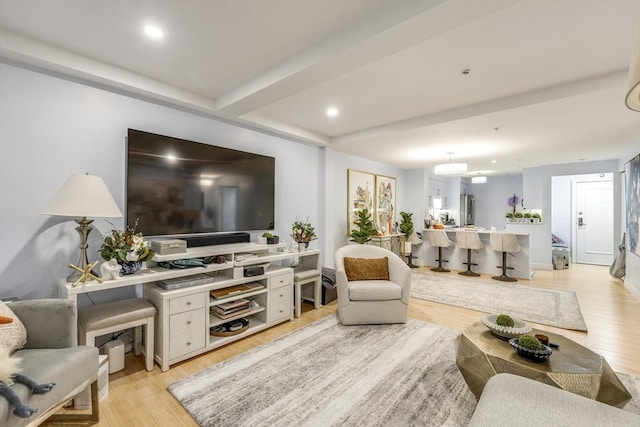 living area with light wood-type flooring and recessed lighting