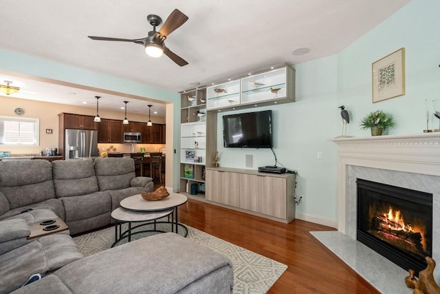 16 Boatwrights Loop, Plymouth, MA 02360 - living room with a premium fireplace, baseboards, a ceiling fan, and wood finished floors
