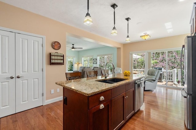 16 Boatwrights Loop, Plymouth, MA 02360 - kitchen featuring a sink, light wood-style flooring, open floor plan, and appliances with stainless steel finishes