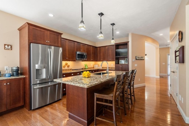 16 Boatwrights Loop, Plymouth, MA 02360 - kitchen featuring a sink, light wood-type flooring, recessed lighting, arched walkways, and appliances with stainless steel finishes