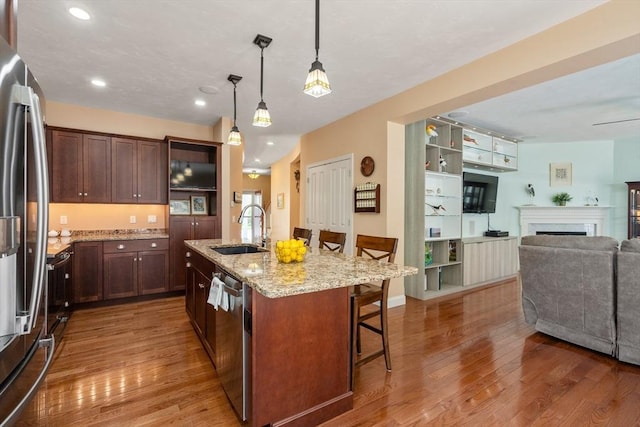 16 Boatwrights Loop, Plymouth, MA 02360 - kitchen with a sink, stainless steel appliances, a breakfast bar area, and wood finished floors