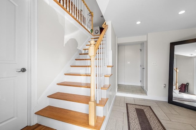 stairs with recessed lighting and baseboards