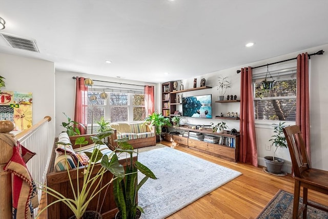 living room with visible vents, wood finished floors, and recessed lighting