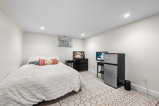 bedroom featuring light carpet, recessed lighting, freestanding refrigerator, and baseboards