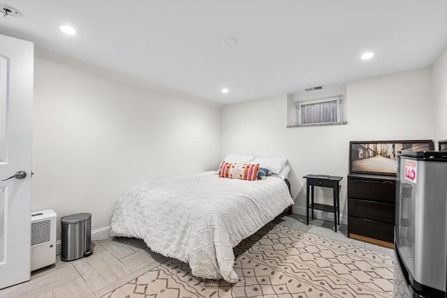 bedroom with baseboards, water heater, visible vents, and recessed lighting