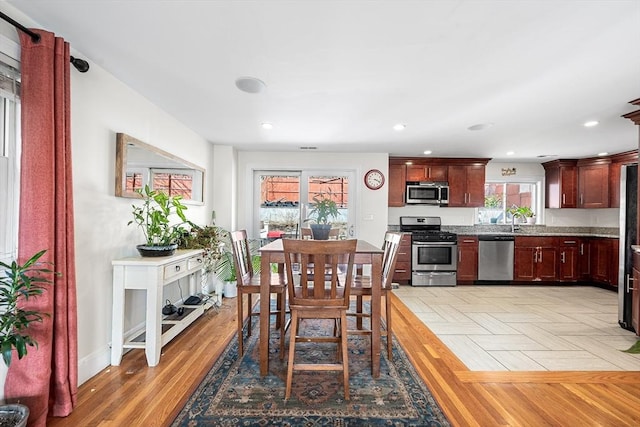 dining area featuring recessed lighting, parquet floors, and baseboards